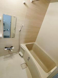 a bathroom with a sink and a mirror at STUDIO YONEGAHAMA l 米が浜通 in Yokosuka