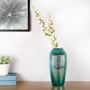 a green vase with flowers in it sitting on a table at OFF Covent Garden SUPERB SPACIOUS BRIGHT LUXXE DESIGN HOME- YOUR WISH GRANTED! in London