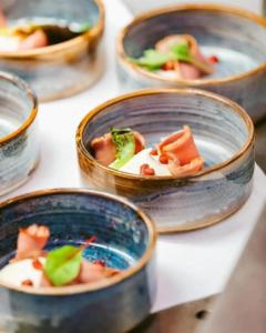 a group of bowls of food on a table at OFF Covent Garden SUPERB SPACIOUS BRIGHT LUXXE DESIGN HOME- YOUR WISH GRANTED! in London