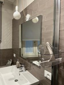 a bathroom with a sink and a mirror at Ca'Sazen Trilo 19 in Brescia
