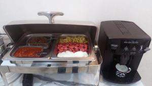 a tray of food sitting next to a coffee maker at Jahongir Premium in Samarkand