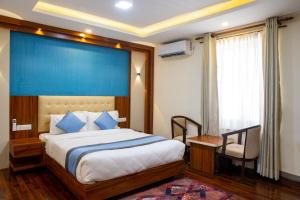 a bedroom with a large bed with a blue wall at Hotel Dreams Connect GRB 2 in Kathmandu