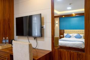 a hotel room with a bed and a flat screen tv at Hotel Dreams Connect GRB 2 in Kathmandu