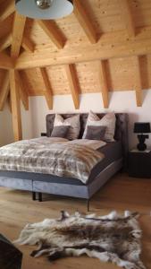 a bed in a room with a wooden ceiling at Villa Florentina in Bad Wörishofen