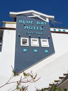 a sign for a blue bay hotel café bar at Blue Bay Beach Hotel in Koinyra