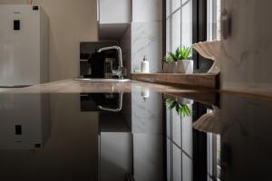 a kitchen with a sink and a mirror in a room at Mal'ovanka in Bukovel