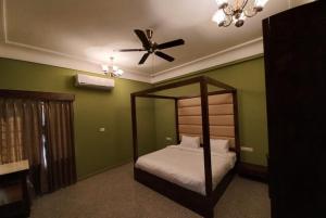a bedroom with a canopy bed and a ceiling fan at SHANKAR NIWAS-A BOUTIQUE HOTEL in Udaipur