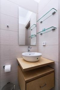 a bathroom with a sink and a mirror at Studio Papadia in Pitsidia