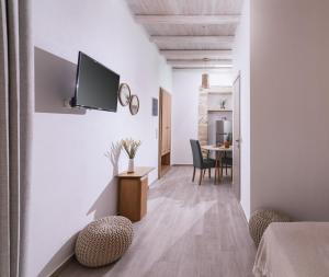 a living room with a tv on a white wall at Studio Papadia in Pitsidia