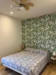 a bedroom with a bed with a green and white wallpaper at CaseMaggi Sea View Terrace in Portovenere