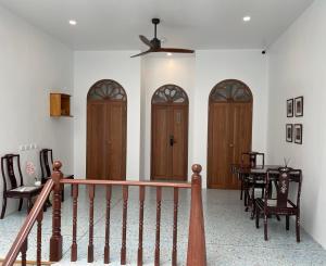 a room with wooden doors and a table and chairs at The Elements Boutique House in Phuket Town