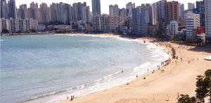 a beach in front of a city with tall buildings at Emotional cafe street Stay in Busan