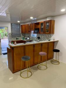 a kitchen with two bar stools and a counter at Charming 1-Bed House in Georgetown in Georgetown