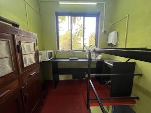 a room with a desk and a window at Rocky in Mumbai +10 photos