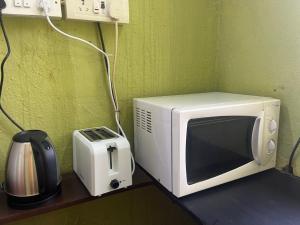 a microwave and a toaster sitting on a counter at Rocky in Mumbai