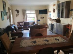 a living room with a table and a couch at Captain's Sea Cabin in Cape Town