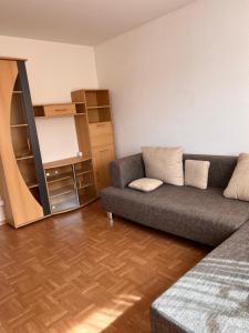 a living room with a couch and a book shelf at Gäste-, Handwerkerzimmer in Rosenfeld