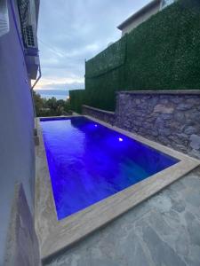 a swimming pool with blue water in a yard at Villa Panorama Sapanca in Sapanca
