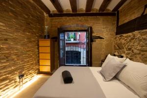 a bedroom with a bed in a brick wall at Palacio del Marqués en Logroño con parking próximo in Logroño