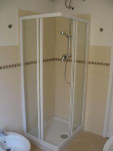a shower with a glass door in a bathroom at Apartment with private Garden in Finale Ligure