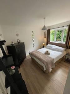 a bedroom with a large bed and a window at Home in Wirral - Peaceful Contemporary Gem. in Wirral