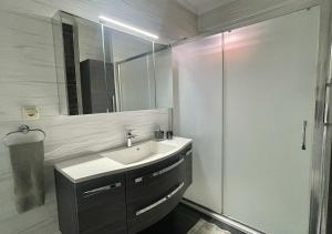 a bathroom with a sink and a mirror and a shower at Deniz Manzaralı, Plaja 100 Metre, Luks Daire 3 in Marmaris