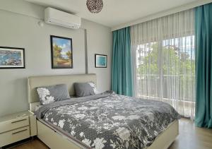 a bedroom with a bed and a large window at Deniz Manzaralı, Plaja 100 Metre, Luks Daire 3 in Marmaris