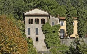 a large house on the side of a hill at Affittacamere La Foresta di Sopra in Barga