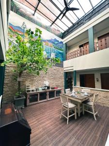 a patio with a table and chairs and a mural at Lugano Arte Homestay in Jakarta