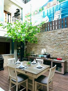 a wooden table and chairs on a patio at Lugano Arte Homestay in Jakarta