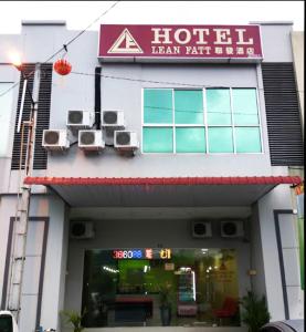 a hotel with two chairs on the front of it at Hotel Lean Fatt in Ipoh