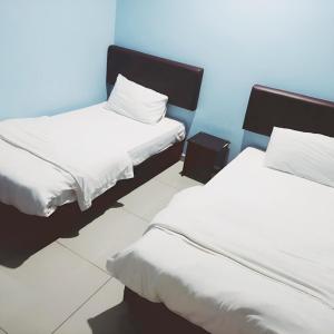 Postel nebo postele na pokoji v ubytování Hotel Lean Fatt