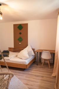 a small room with a bed and a table at Ferienwohnung Naturini in Freiburg im Breisgau