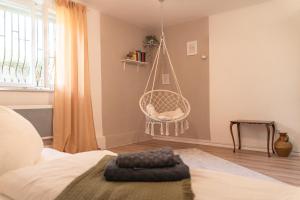 a room with a bed and a hanging chair at Ferienwohnung Naturini in Freiburg im Breisgau