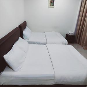 Postel nebo postele na pokoji v ubytování Hotel Lean Fatt