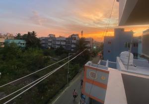 a view of the sunset from a balcony of a building at The waves in Chennai