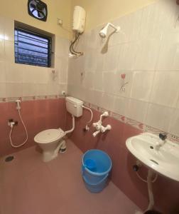a bathroom with a toilet and a sink at The waves in Chennai