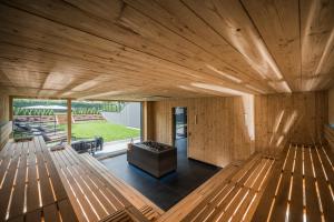 a wooden house with a large living room with a fireplace at Montanaris Alpine - Active - Relax in Villabassa +66 photos