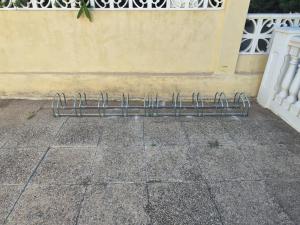 a metal object sitting on a sidewalk next to a building at Aparthotel Carrio Sol - Monty´s in Calpe