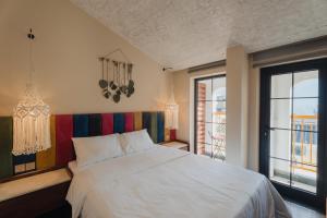 a bedroom with a white bed and a window at May Casa in Sa Pa