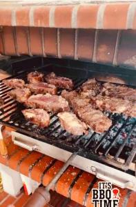 a grill with meat and other food cooking on it at Paradise House Ground floor apartment in Villa with private pool and private garden in Abrantes