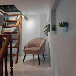 a chair sitting in a room with a staircase at Paradise House Ground floor apartment in Villa with private pool and private garden in Abrantes