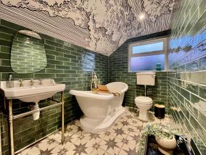 a bathroom with a sink and a toilet and a sink at Style House by Flying Stays. in Tenby +17 photos