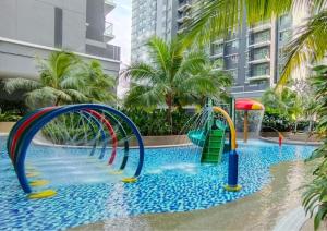 a pool with a water slide in a resort at 2R2B Comfy Homestay, 1-6 Pax - GA4 in Shah Alam