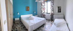 Postel nebo postele na pokoji v ubytování B&B L'Oasi