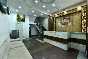 a lobby with a reception desk and a staircase at Royal Inn in Jammu