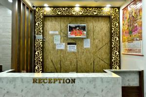 a reception desk in front of a wooden door at Royal Inn in Jammu