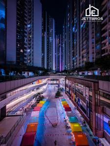 a large building with colorful lights in a city at night at R&F Princess Cove By JettBros Johor Bahru in Johor Bahru