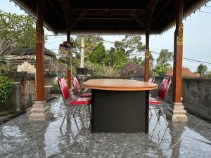 a group of chairs sitting around a table on a patio at Umah Desa in Banjarangkan