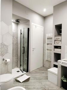 a white bathroom with a shower and a toilet at La casa dei ricordi in Cagliari